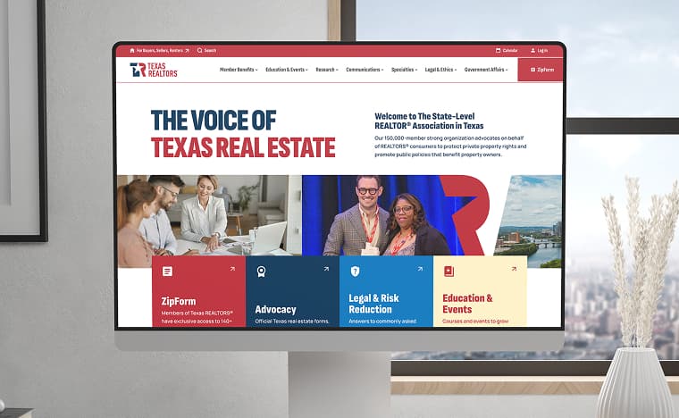 Desktop monitor showing the Texas REALTORS® homepage - “The Voice of Texas Real Estate” with member benefit tiles
